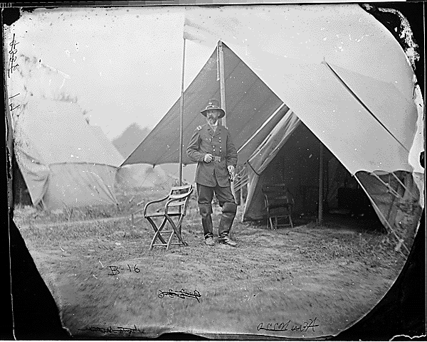 Black and white photo of a union solider near his tent.