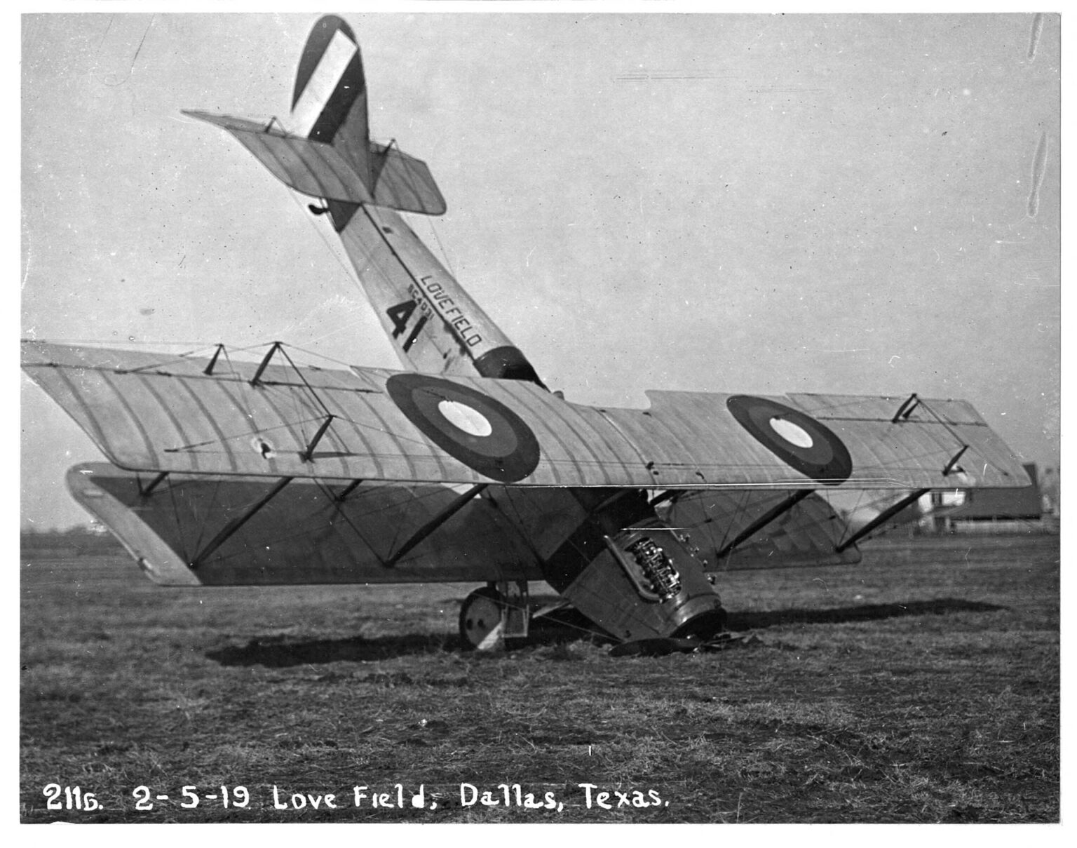 Black and white photo of plane crashed into a field in Dallas nose down.